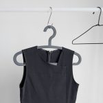 black sleeveless top hanging on wardrobe