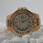 gold and white analog watch at 10 10