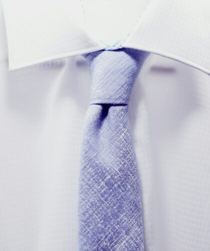 close up photo white collared shirt with blue necktie